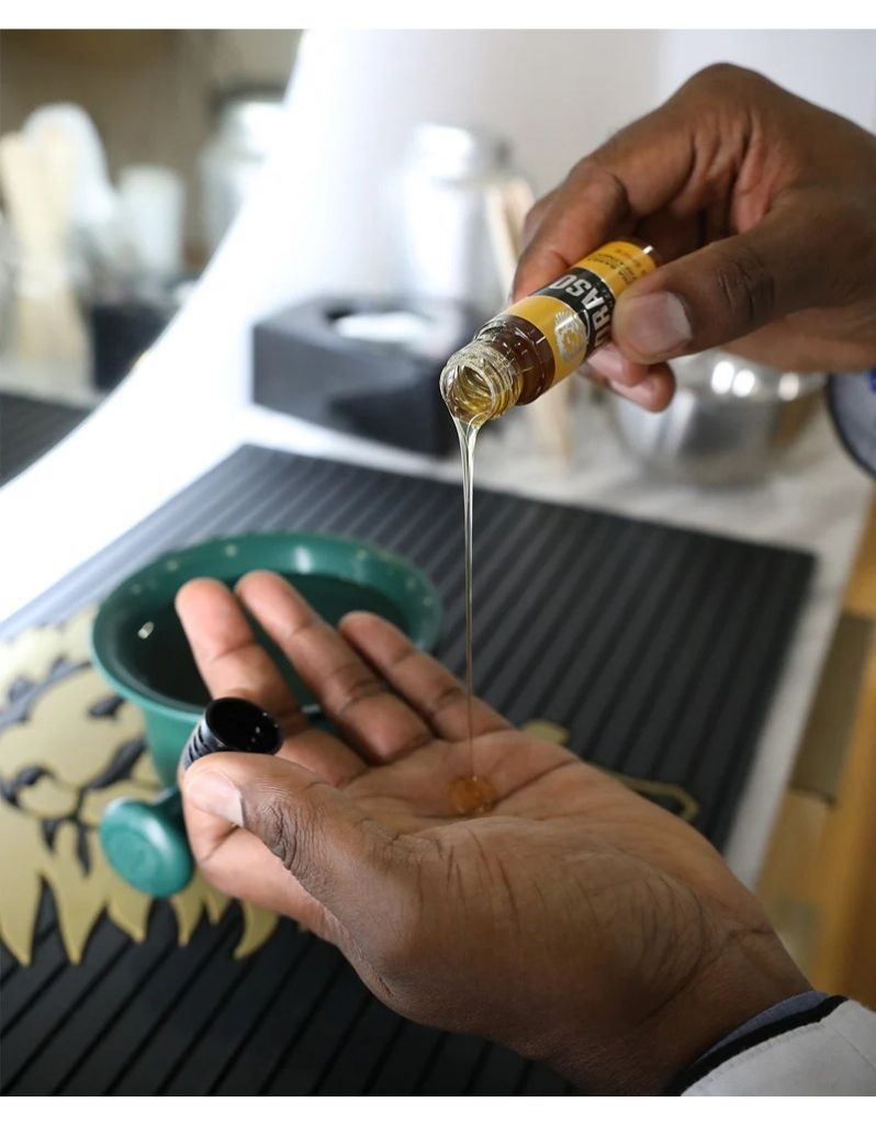 Pouring the hot oil beard treatment into hand