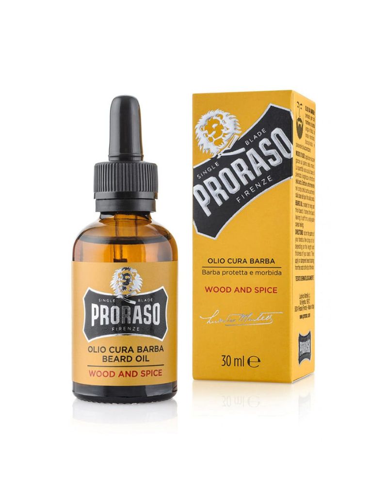 A bottle of Proraso Beard Oil with a dropper cap, labeled 'Wood & Spice'. The product is displayed next to its packaging box