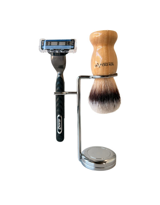 Stand holding a wooden handle synthetic bristles shaving brush and a Mach3 razor. 