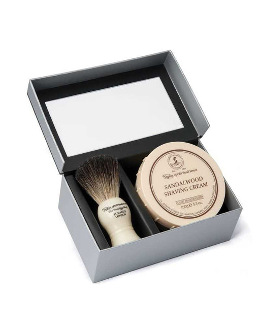 Shaving brush and sandalwood shaving cream in a gray gift box on a white background.