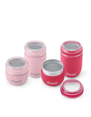 Four S'well insulated containers in shades of pink and magenta, arranged on a clean white background. Two jars are open, showing clear lids with silver metal rims, and the brand name 'S'well' is printed in white on the front of each jar.