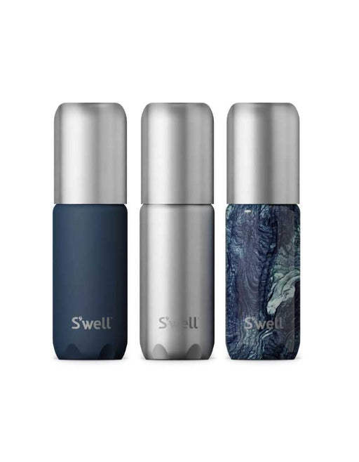 Three S'well travel bottles in blue, silver, and marbled design on a white background