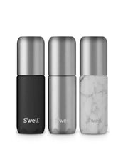 Three S'well travel bottles in black, silver, and marble design on a white background