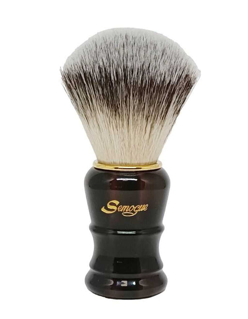 A Semogue shaving brush with a glossy tortoiseshell handle and fan shaped synthetic bristles.