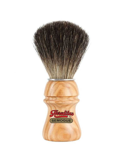 A Semogue shaving brush with black badger bristles and an ash wood handle with a matte finish. The handle features a chrome plated ring.