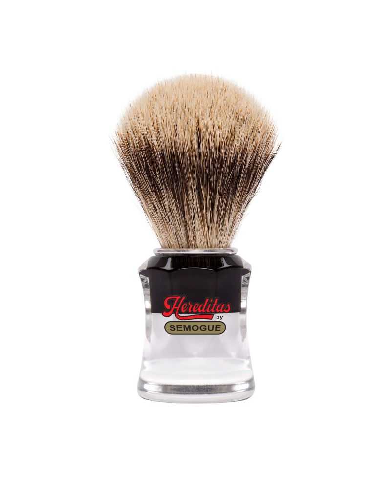 A Semogue 730 HD Hereditas badger shaving brush with a black and clear striped handle and a fan-shaped knot of bristles.