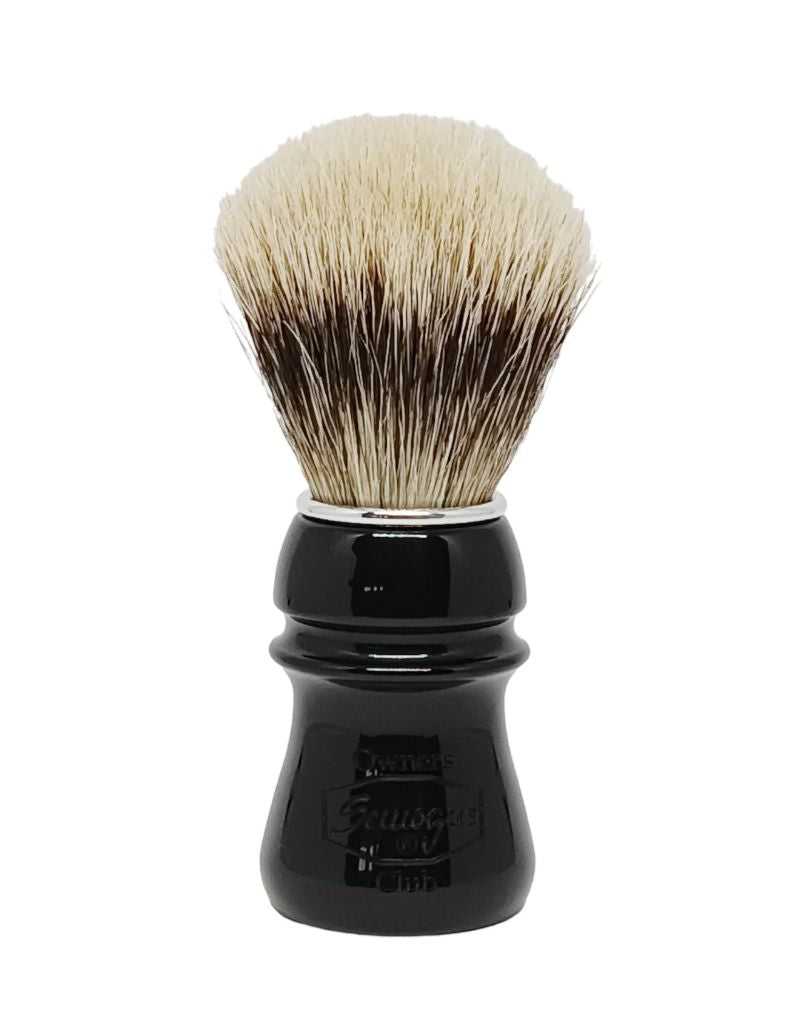A Semogue shaving brush with a jet black handle and a fan-shaped knot of bristles.