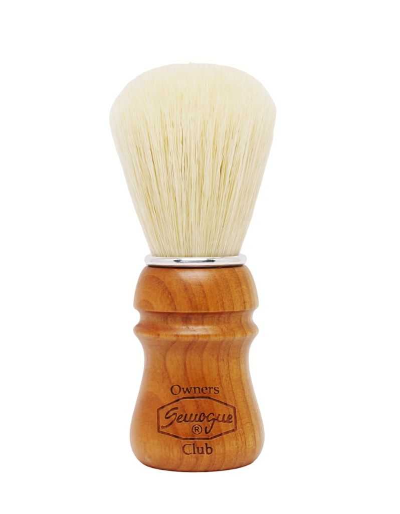 Shaving brush with wooden handle and white bristles on a white background