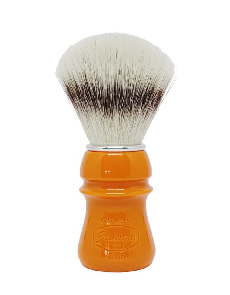 A Semogue Owner's Club C5 synthetic shaving brush with a butterscotch-colored handle and a fan-shaped knot of bristles.