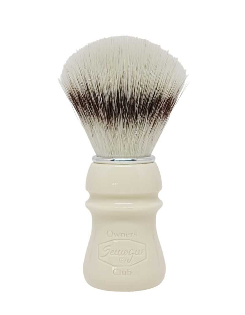 A Semogue Owner's Club C5 synthetic shaving brush with a Taj handle and a fan-shaped knot of bristles.