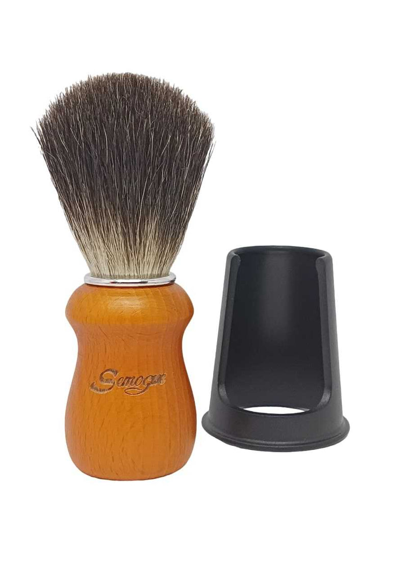 A Semogue Pharos C3 pure black badger shaving brush with a yellow wood handle and a chrome plated ring, displayed alongside its black brush holder.