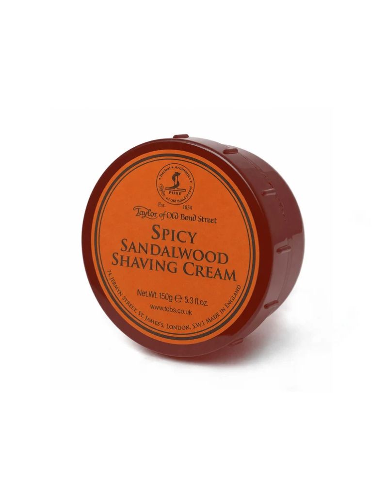 A round reddish-brown plastic tub of Taylor of Old Bond Street Spicy Sandalwood Shaving Cream, featuring an orange circular label, set against a plain white background.