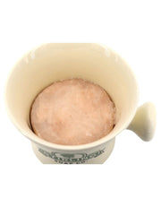 Cream color ceramic mug with shaving soap puck inserted