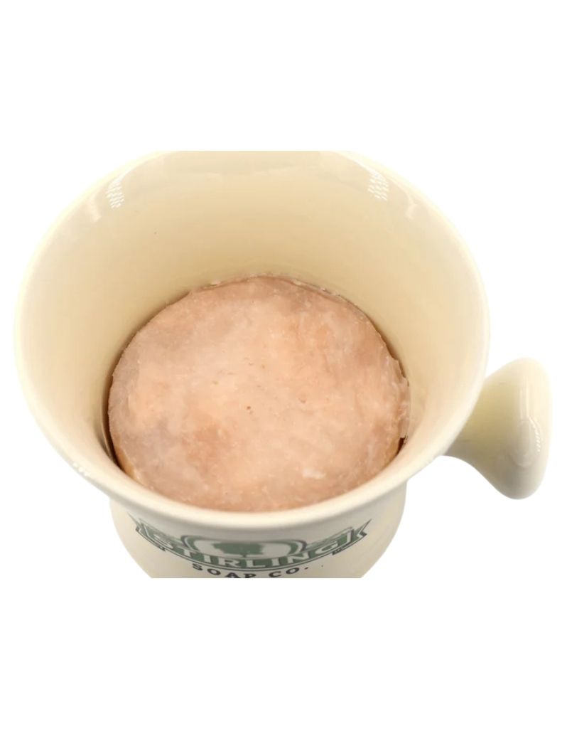 Cream color ceramic mug with shaving soap puck inserted