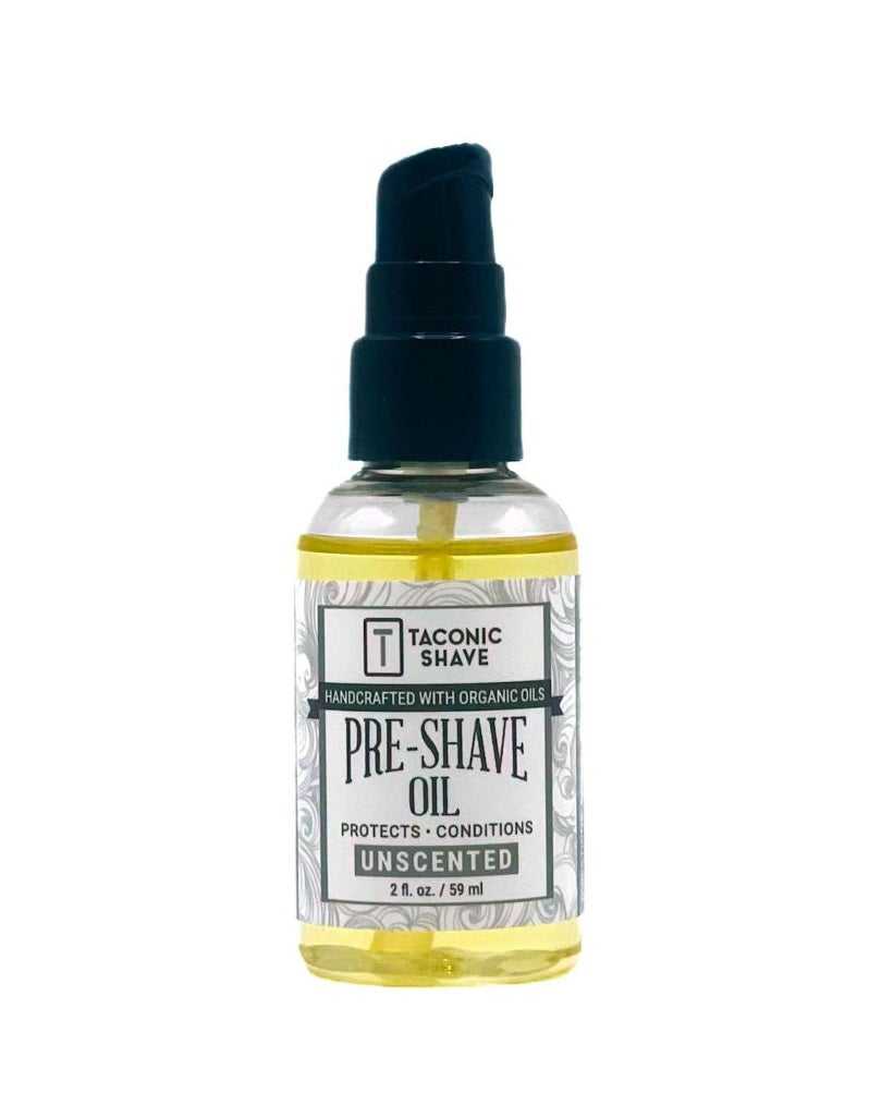 A bottle of Taconic Shave Pre-Shave Oil with a dropper, labeled as unscented organic.