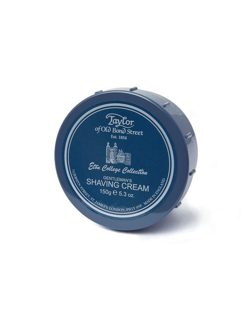 A container of Taylor of Old Bond Street Eton College Shaving Cream with blue lid and label, indicating it is part of the Eton College Collection.