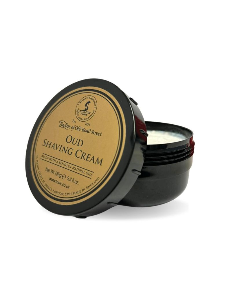 A container of Taylor of Old Bond Street Oud Shaving Cream with the lid open, showing the shaving cream inside.