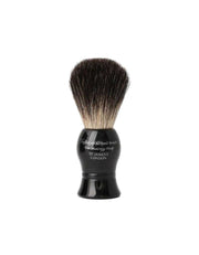 Shaving brush with black handle and bristles on a white background