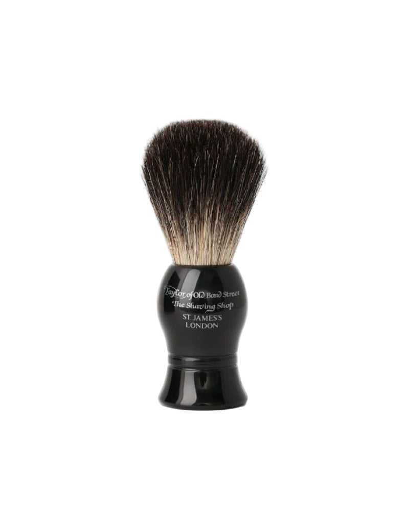 Shaving brush with black handle and bristles on a white background