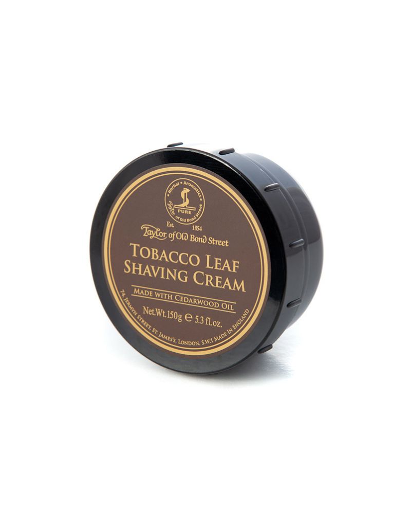 A round container of Taylor of Old Bond Street Tobacco Leaf Shaving Cream with a black lid and a label on the front.