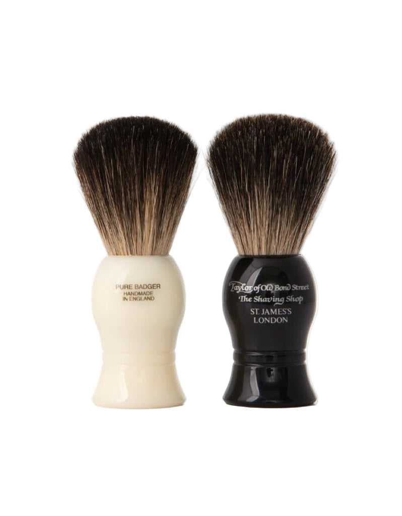 Two shaving brushes, one white and one black, on a white background.
