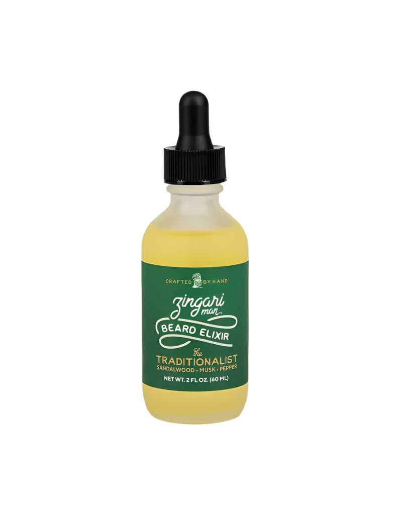 The Traditionalist Beard Elixir in a 2 oz frosted glass bottle with natural oils and a classic citrus-tobacco-wood scent.