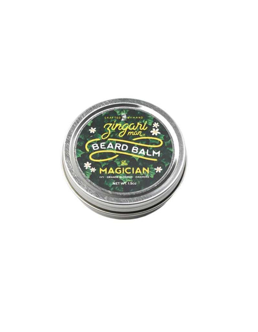 The Magician Beard Balm in a travel-sized tin with natural oils and a green citrus scent inspired by the stillness of the forest.