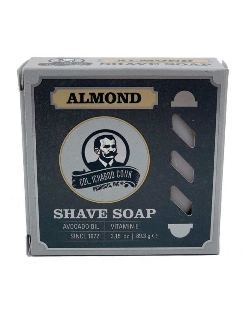 A packaged Colonel Conk Almond Shave Soap puck in a cardboard box with branding and product information displayed.