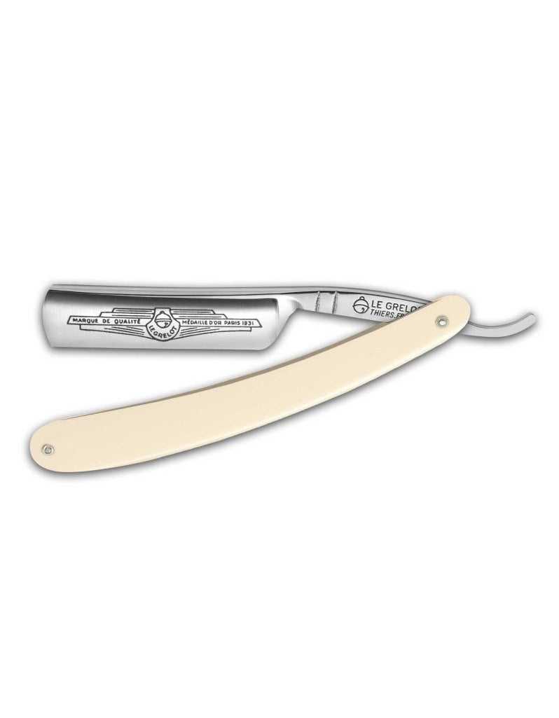 A Thiers Issard straight razor with a round point, featuring a polished silver blade and a beige wooden handle.